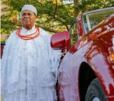 Esama Of Benin Poses Behind His Luxury Car