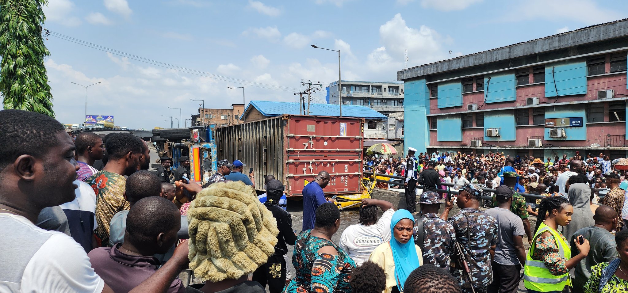 BREAKING: Outrage As Container Falls On Bus At Ojuelegba Bridge